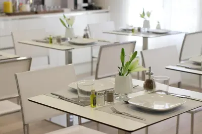 a white table with plates and utensils on it at The 8 Boutique B&B in Barcelona