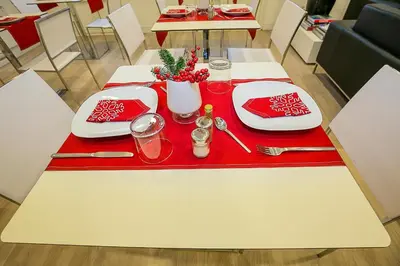 a table with red and white plates and utensils at The 8 Boutique B&B in Barcelona