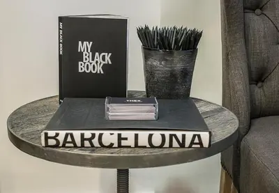 a book on a table next to a chair at The 8 Boutique B&B in Barcelona