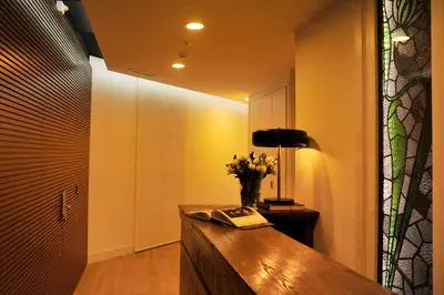 a hallway with a desk with a vase of flowers and a lamp at The 8 Boutique B&B in Barcelona