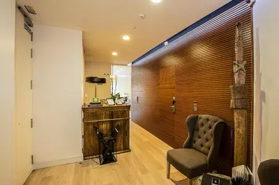 a living room with a chair and a wall at The 8 Boutique B&B in Barcelona