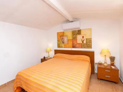 a bedroom with a bed and two night stands at Holiday Home Remedios by Interhome in Cunit