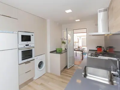 a kitchen with a sink and a washing machine at Holiday Home Remedios by Interhome in Cunit