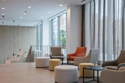 a waiting room with chairs and tables and windows at Acta Voraport in Barcelona