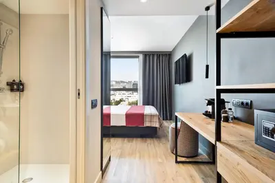 a hotel room with a bed and a bathroom at Acta Voraport in Barcelona