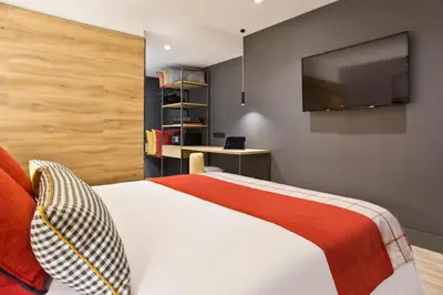 a bedroom with a bed with a flat screen tv at Acta Voraport in Barcelona