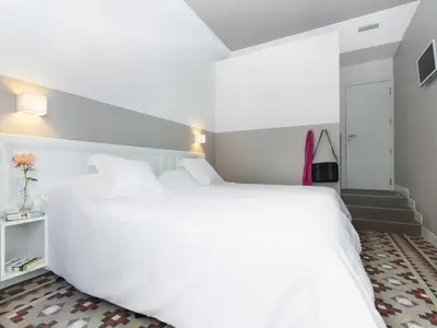a white bedroom with a large white bed at Ecozentric in Barcelona