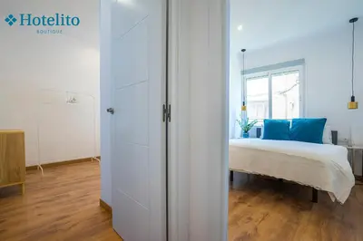 a white bedroom with a bed and a window at Hotelito Boutique Badalona Mar in Badalona