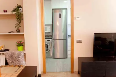 a kitchen with a stainless steel refrigerator and a microwave at Alcam Barbera Terrazas in Barbera del Valles