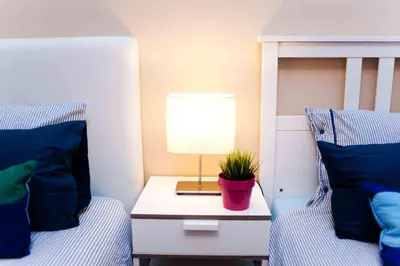 a bedroom with two beds and a table with a lamp at Alcam Barbera Terrazas in Barbera del Valles