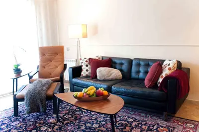 a living room with a couch and a bowl of fruit on a table at Alcam Barbera Terrazas in Barbera del Valles