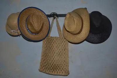 two hats and a bag hanging on a wall at RCP El Racó in Pacs del Penedes