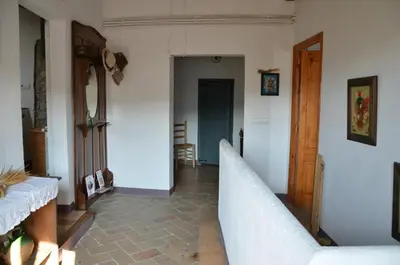 a living room with a hallway with a couch at RCP El Racó in Pacs del Penedes