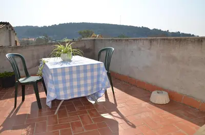 a table with a checkered table cloth on a patio at RCP El Racó in Pacs del Penedes