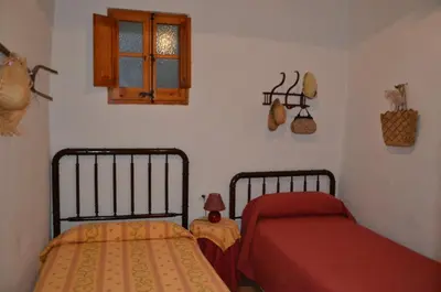 a bedroom with two beds and a window at RCP El Racó in Pacs del Penedes