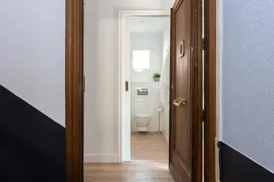 an open door to a bathroom with a toilet at Casa Cosi - Atico in Barcelona