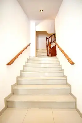 a staircase in a house with white walls and wooden railings at Sono Master Apartments in La Garriga