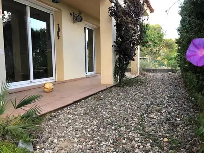a house with a ball sitting on the side of a yard at Casa Bella Vista en montaña con vistas al mar y piscina privada in Cunit
