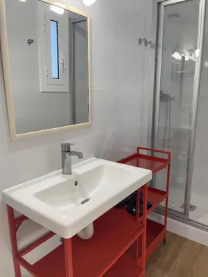 a bathroom with a white sink and a shower at Sunny Apartments in Sitges
