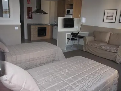 a living room with a bed and a couch at Apartments HHB in Barcelona