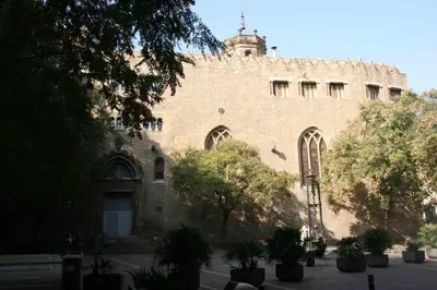 a large brick building with trees in front of it at Apartments HHB in Barcelona