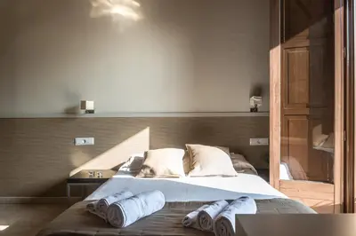 a bedroom with a bed with towels on it at Apartments HHB in Barcelona
