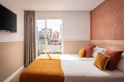 a hotel room with a bed and a window at BYPILLOW House in Barcelona