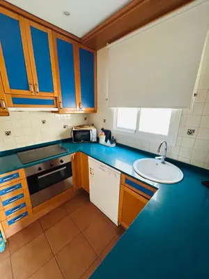 a kitchen with blue counters and a sink at Sweet Atic in Sitges