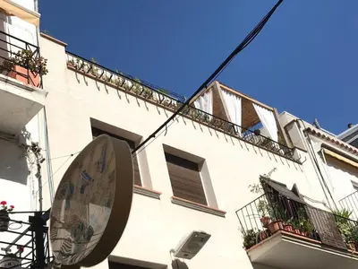 a sign on the side of a building at Sweet Atic in Sitges