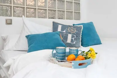 a basket of fruit on a bed with pillows at Stay U-nique Apartments Provença in Barcelona
