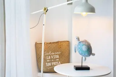 a white table with a lamp and a bag at Stay U-nique Apartments Provença in Barcelona