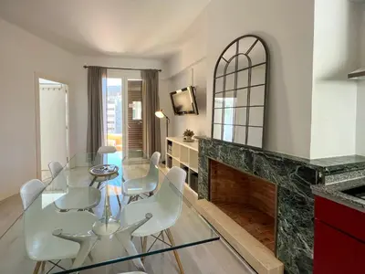 a dining room with a glass table and chairs and a fireplace at Stay U-nique Apartments Sèneca in Barcelona