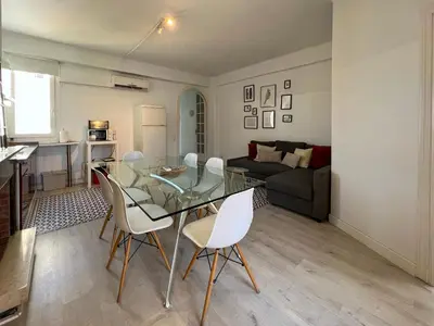 a living room with a glass table and white chairs at Stay U-nique Apartments Sèneca in Barcelona