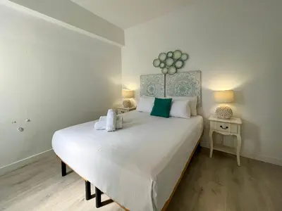 a bedroom with a large white bed with towels on it at Stay U-nique Apartments Sèneca in Barcelona