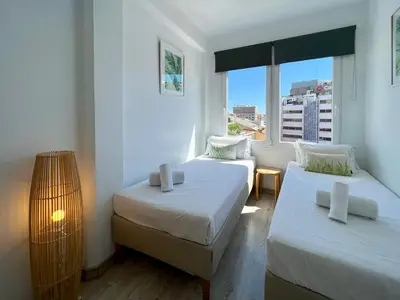 a small room with two beds and a window at Stay U-nique Apartments Sèneca in Barcelona