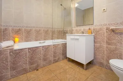 a bathroom with a tub and a toilet and a sink at Stay U-nique Apartments Sicília in Barcelona