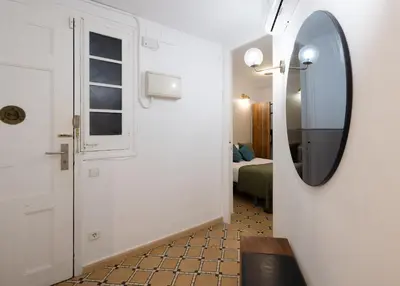 a hallway with a mirror and a room with a bed at Stay U-nique Apartments Floridablanca in Barcelona