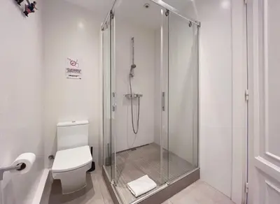 a shower stall in a bathroom with a toilet at Stay U-nique Apartments Roger Llúria in Barcelona