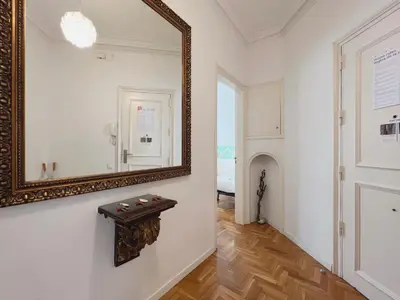 a mirror on a wall next to a hallway at Stay U-nique Apartments Roger Llúria in Barcelona