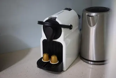 a coffee maker sitting next to a trash can at Stay U-nique Apartments Casanova in Barcelona