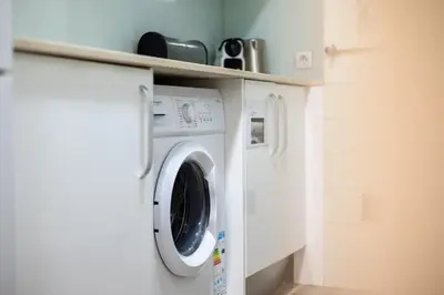 a washer and dryer in a laundry room at Stay U-nique Apartments Casanova in Barcelona