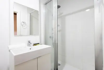 a white bathroom with a sink and a shower at Stay U-nique Apartments Casanova in Barcelona