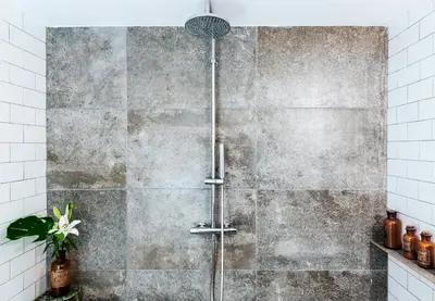 a shower in a bathroom with a concrete wall at Brummell Apartments Eixample Izquierda/Valeris in Barcelona