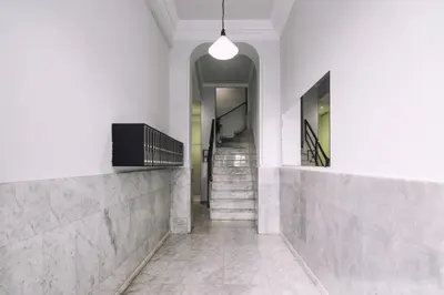 a hallway with stairs and a pendant light at Brummell Apartments Eixample Izquierda/Valeris in Barcelona