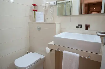 a white bathroom with a sink and a toilet at BacHome Terrace B&B in Barcelona