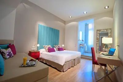a bedroom with a bed and a desk with a laptop at BacHome Terrace B&B in Barcelona