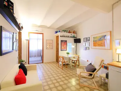 a living room with a couch and a table at Apartment Eixample Dret Valencia - Cartagena by Interhome in Barcelona