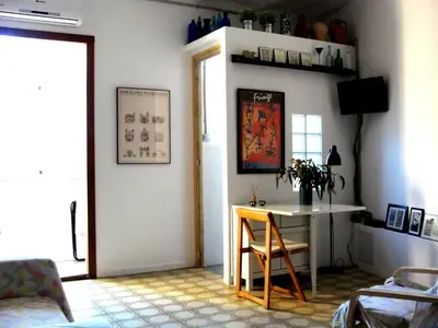 a room with a table and a table and a chair at Apartment Eixample Dret Valencia - Cartagena by Interhome in Barcelona