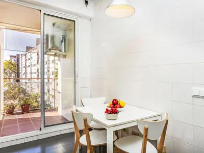 a white dining room with a table and chairs at Apartment Vila Olimpica Sant Marti by Interhome in Barcelona