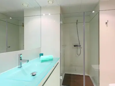 a bathroom with a glass shower and a sink at Apartment Diagonal Mar by Interhome in Barcelona